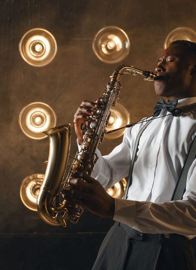 Black jazz performer plays the saxophone on stage