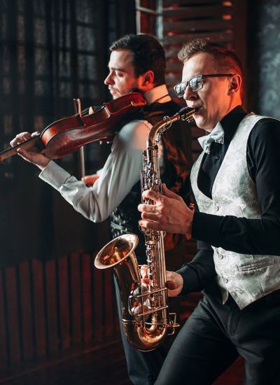 Sax man and fiddler duet playing classical melody